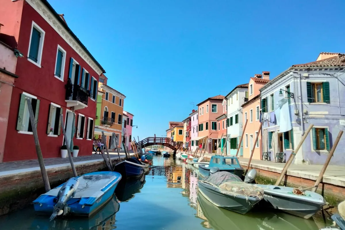Private Venetian motorboat with a small group cruising the calm lagoon towards Burano on a private Murano and Burano tour from Venice, Italy